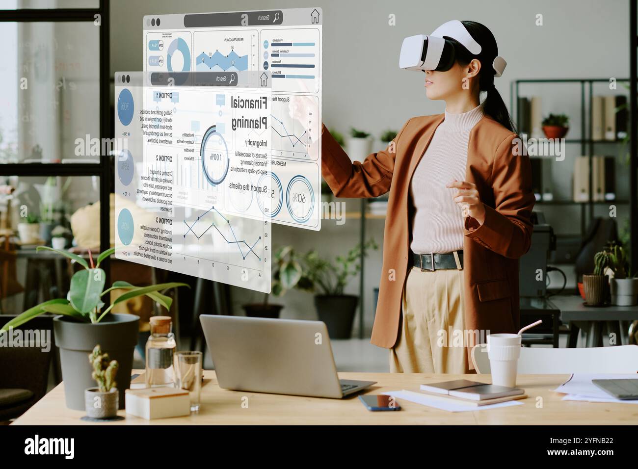 Young Woman Using VR Headset At Work Stock Photo