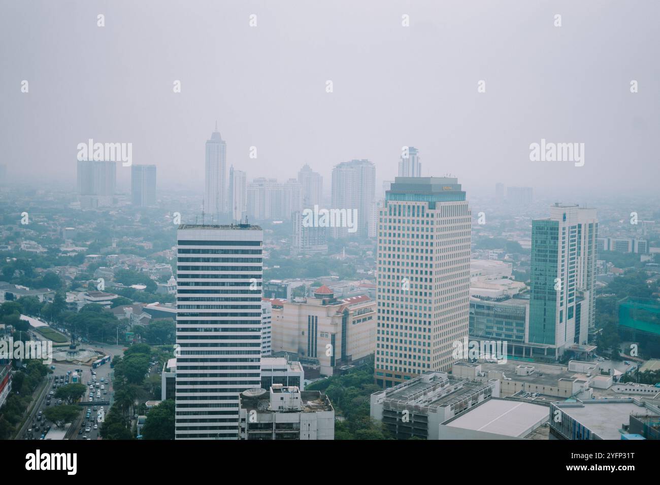 high-rise-buildings-and-a-major-road-in-jakarta-city-with-visible-air