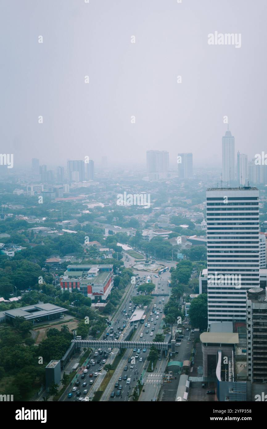 high-rise-buildings-and-a-major-road-in-jakarta-city-with-visible-air