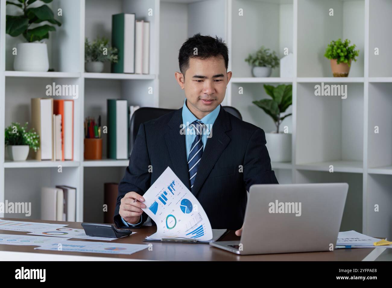 Data Analyst Reviewing Charts for Financial Performance Evaluation ...