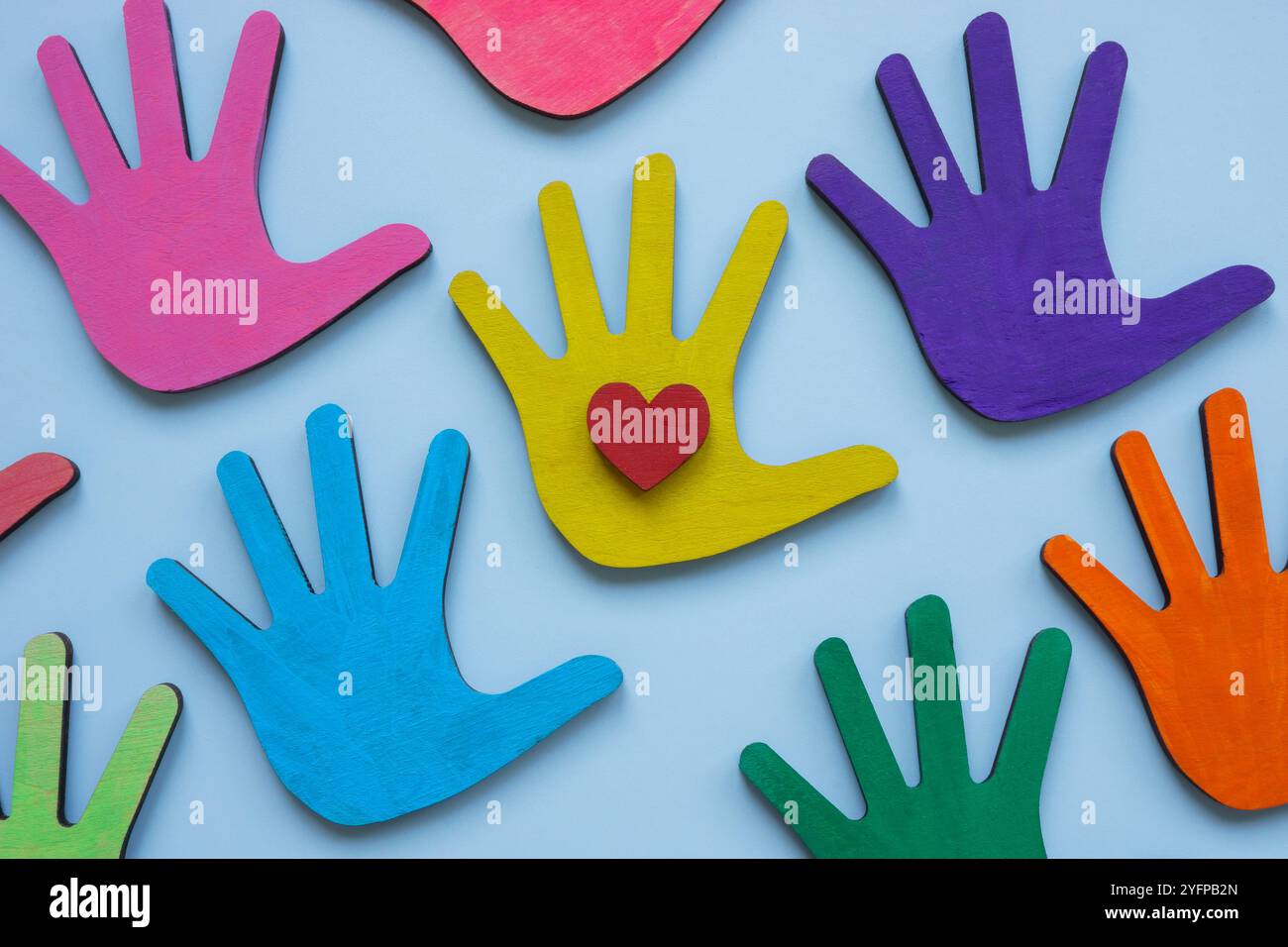 Colorful hands and a heart symbolizing love and diversity in community. Stock Photo