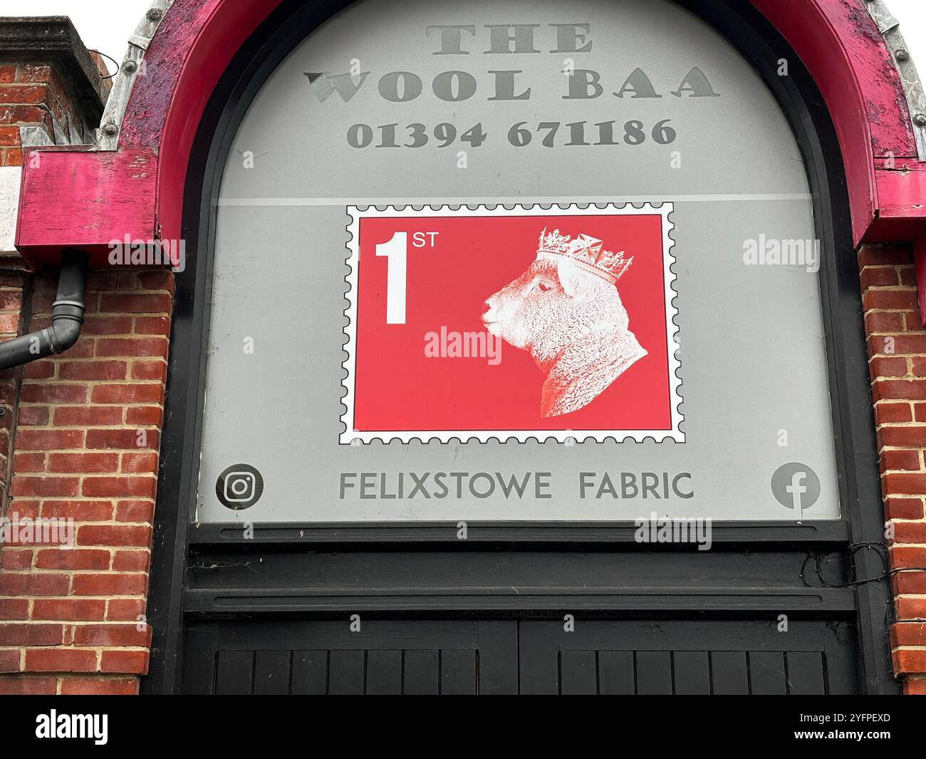 Imitation First Class stamp sign with crowned sheep head, The Wool Baa shop, Felixstowe, Suffolk, England, UK - Smartphone Captured Stock Image