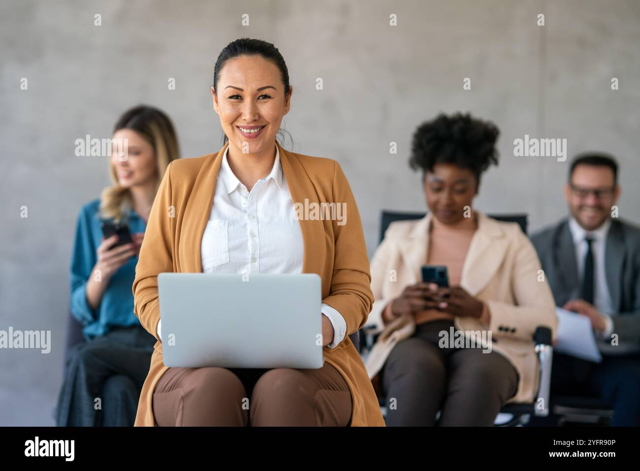 Mixed team of software engineers brainstorming ideas. Diverse app developers collaborating as group Stock Photo