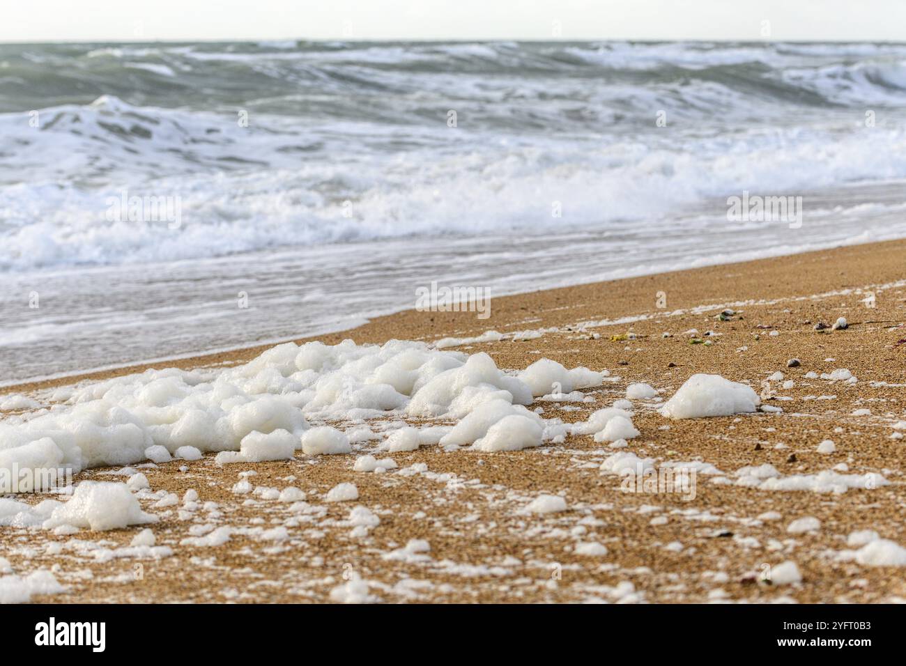 Windswept sea foam on a beach in the Atlantic Ocean near Olonne sur mer in France Stock Photo