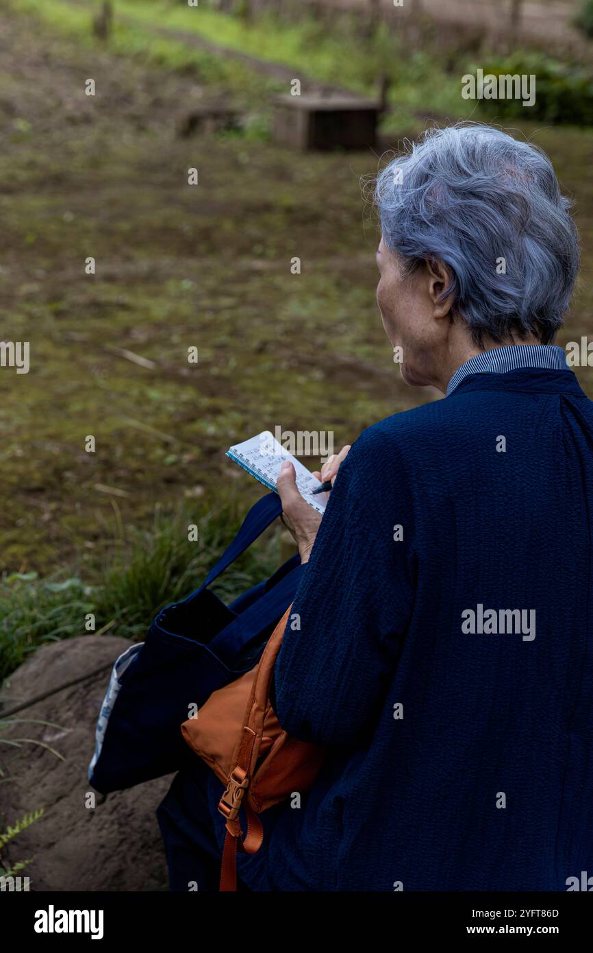 Old japanese woman in Koishikawa Kōrakuen botanical garden, near Tokyo Dome, Tokyo, Japan © Giorgia De Dato Stock Photo