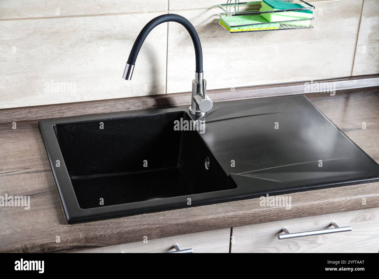 Black Ceramic Stone Kitchen Sink on light brown wooden table. Mock up, Copy space Sink Cleaner Eco friendly Concept Stock Photo