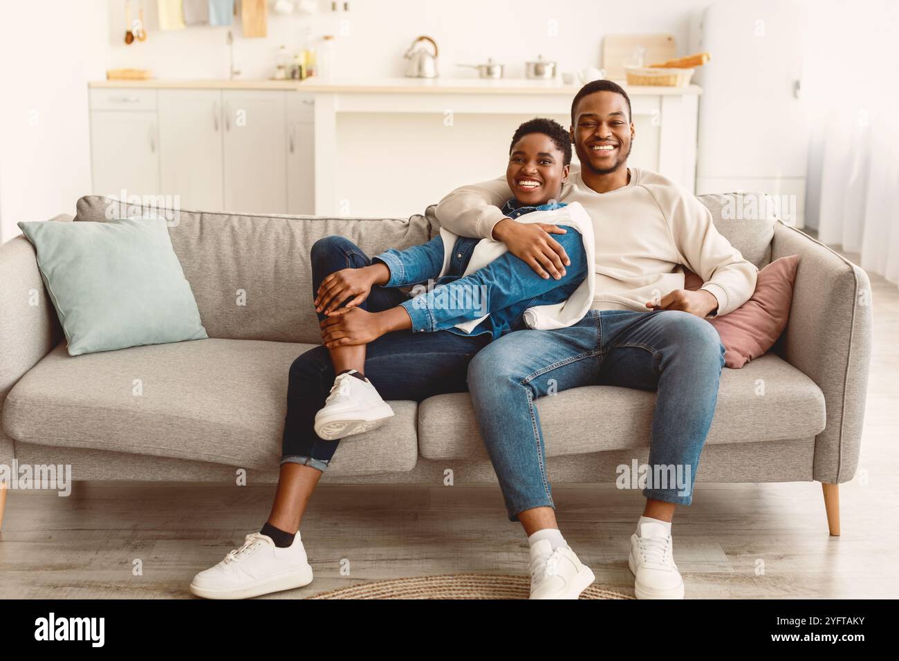African american couple spending weekend together lying on sofa Stock Photo