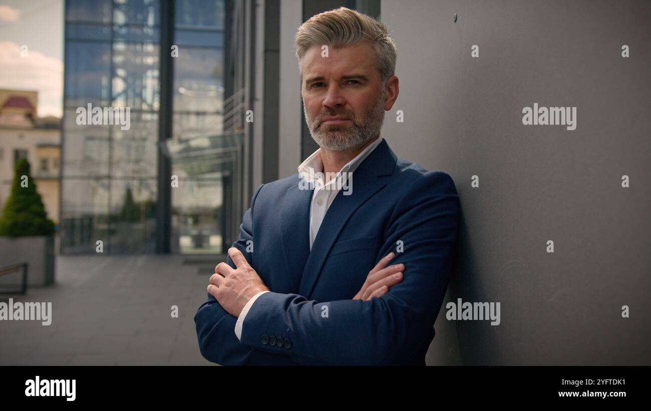 Caucasian middle-aged old man serious confident senior businessman mature retired business male employer 60s entrepreneur investor leader in city Stock Photo