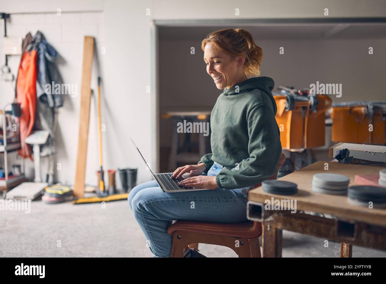Female Worker In Concrete Workshop Using Laptop Computer Stock Photo