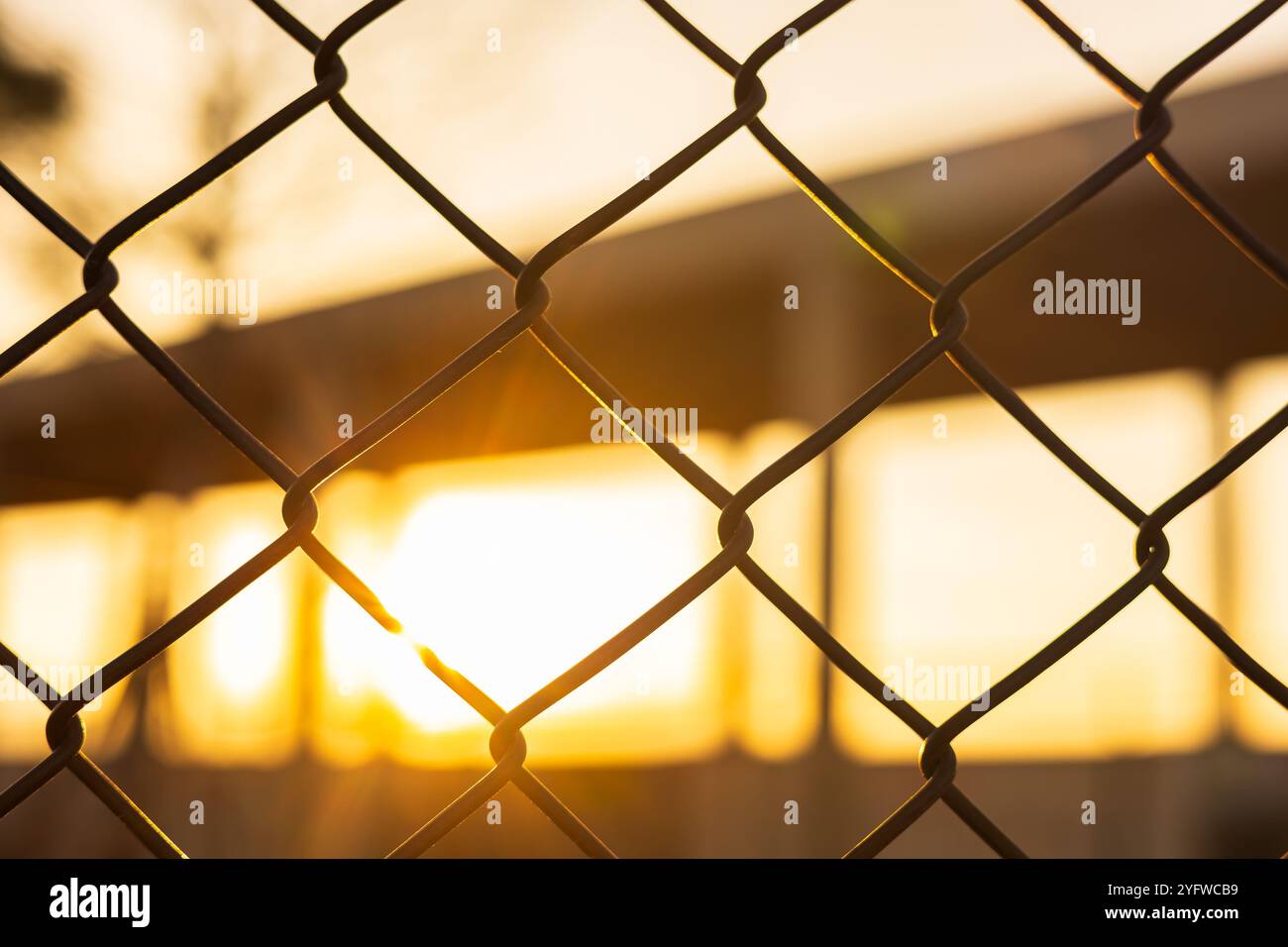 Basketball court fence mesh netting outdoors sport with sunset in the Basketball court fence mesh netting outdoors sport with sunset in the