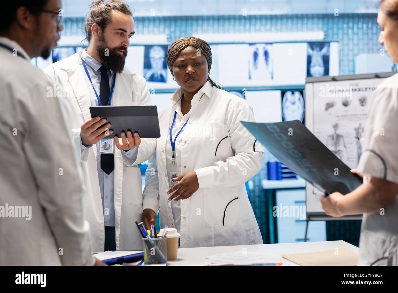 Healthcare team examines x ray results and discusses disease prevention ...