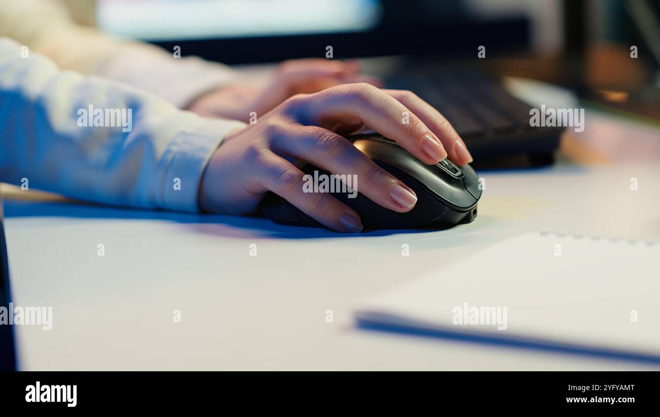 Extreme close up shot of video editor selecting key frames to use while doing video montage, working from home on computer. Woman using mouse to edit movie project footage in studio, camera A Stock Photo