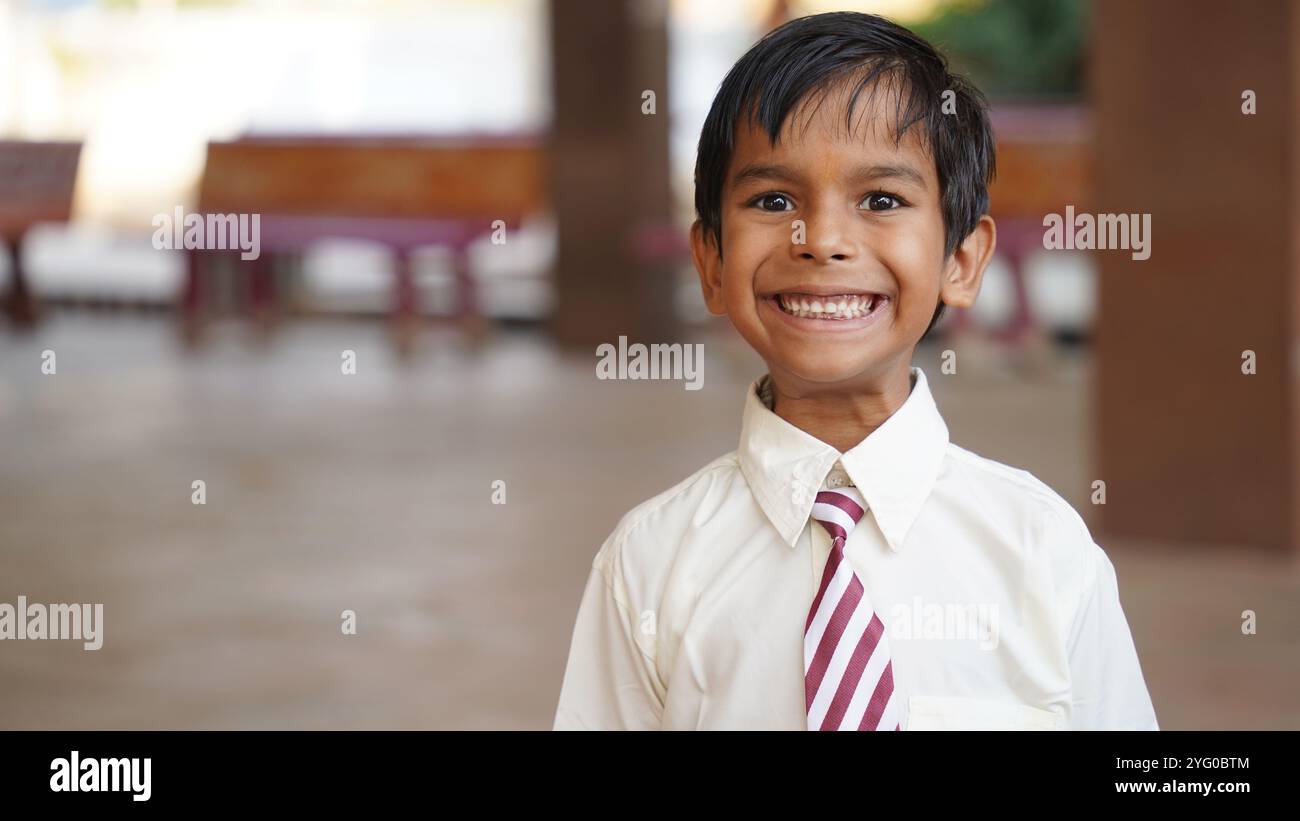 Happy Indian elementary school girls students sitting at desk in classroom with writing in notebook with pencil, Examination and test, female Educatio Stock Photo