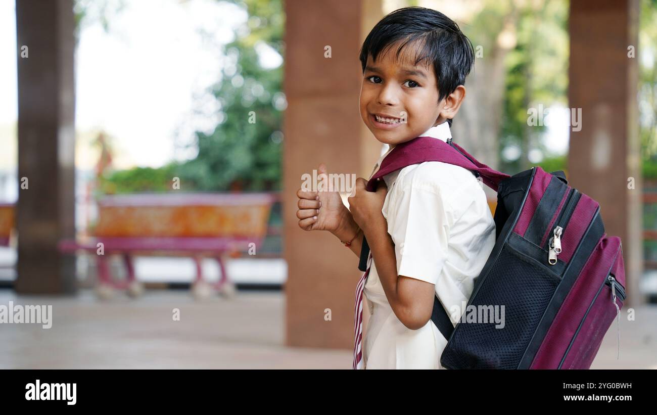 Smiling Rural Kid Smiling Indian Rural school boy with backpack looking at camera ...