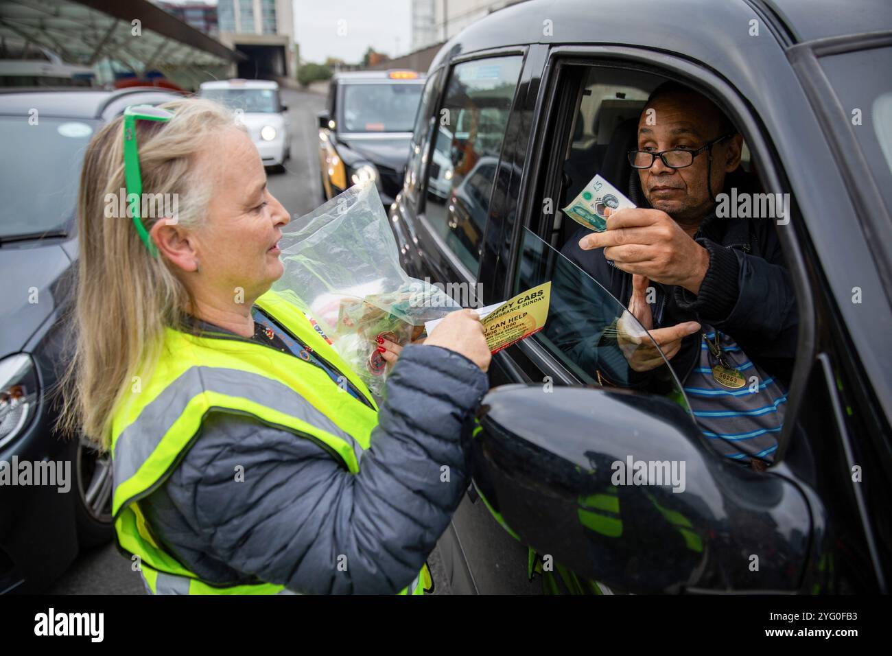 London, UK. 3rd Nov, 2024. A London Taxi driver makes a donation to a ...