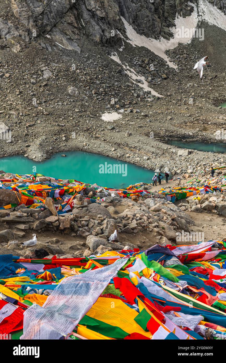 Tibetan praying flags at the Gauri Kund mountain lake during the ritual ...