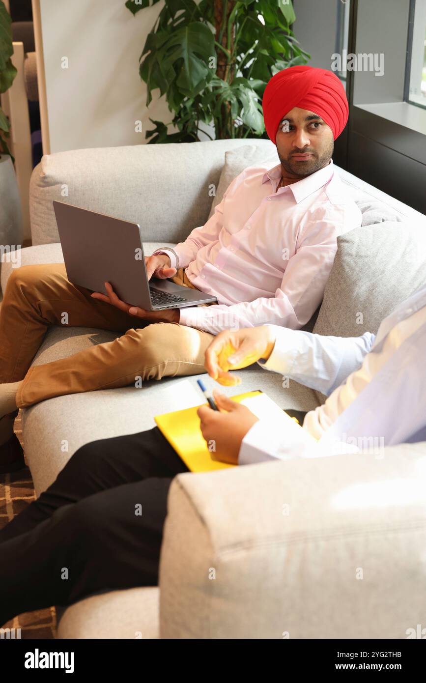 Two businessmen sitting in office Stock Photo