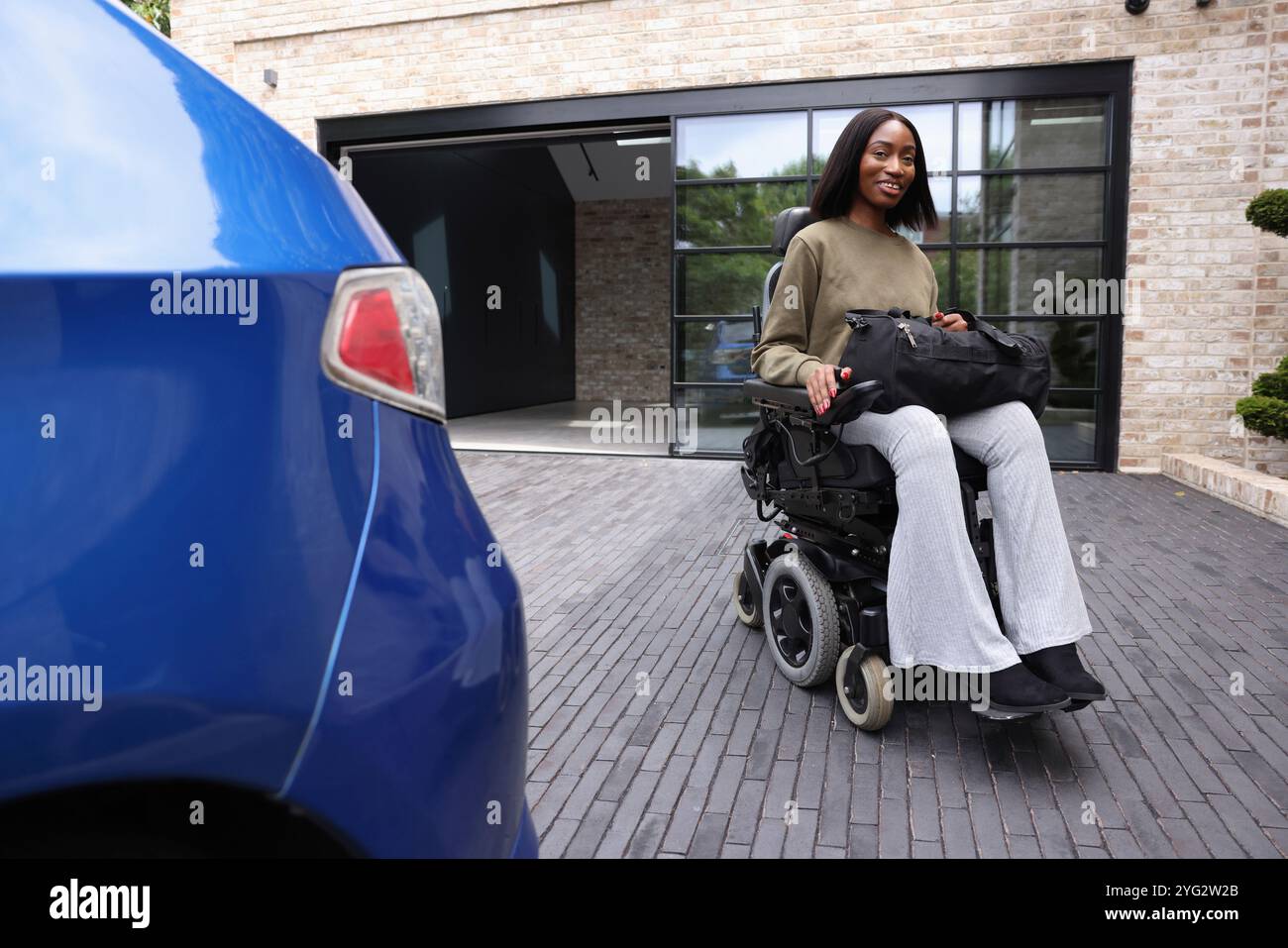 Woman in wheelchair looking camera hi-res stock photography and images ...