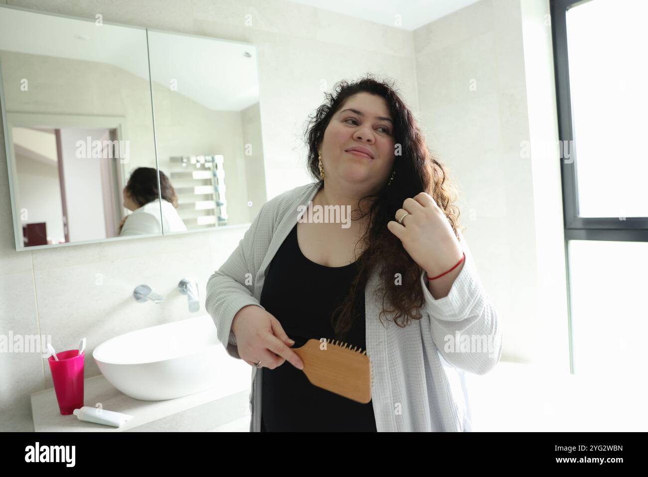Woman brushing hair Stock Photo