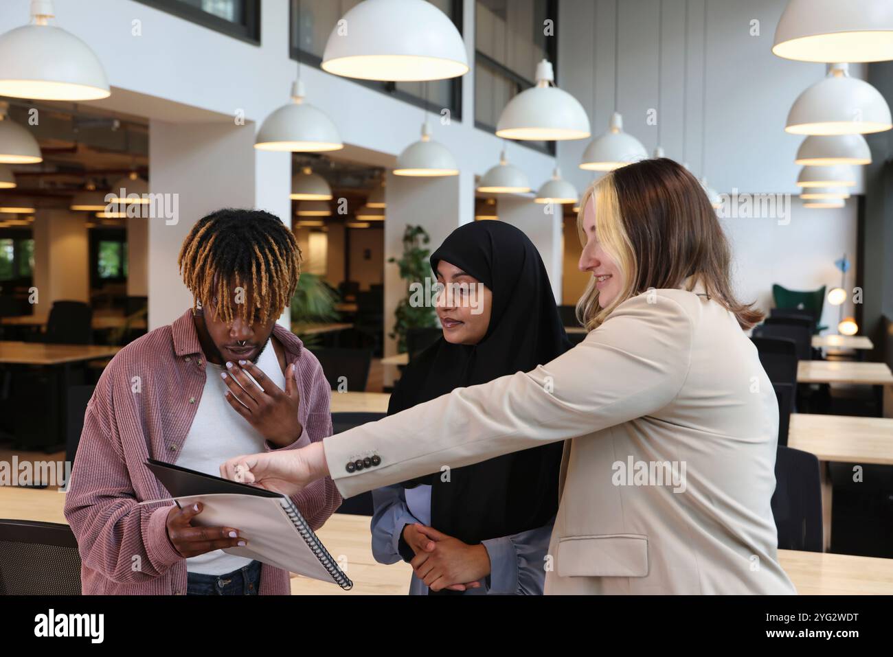 Two businesswomen and businessman discussing in office Stock Photo