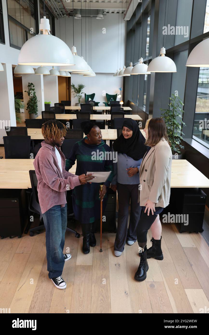 Diverse group of business people discussing in office Stock Photo