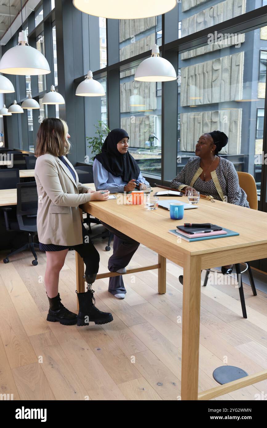 Three businesswomen in office Stock Photo