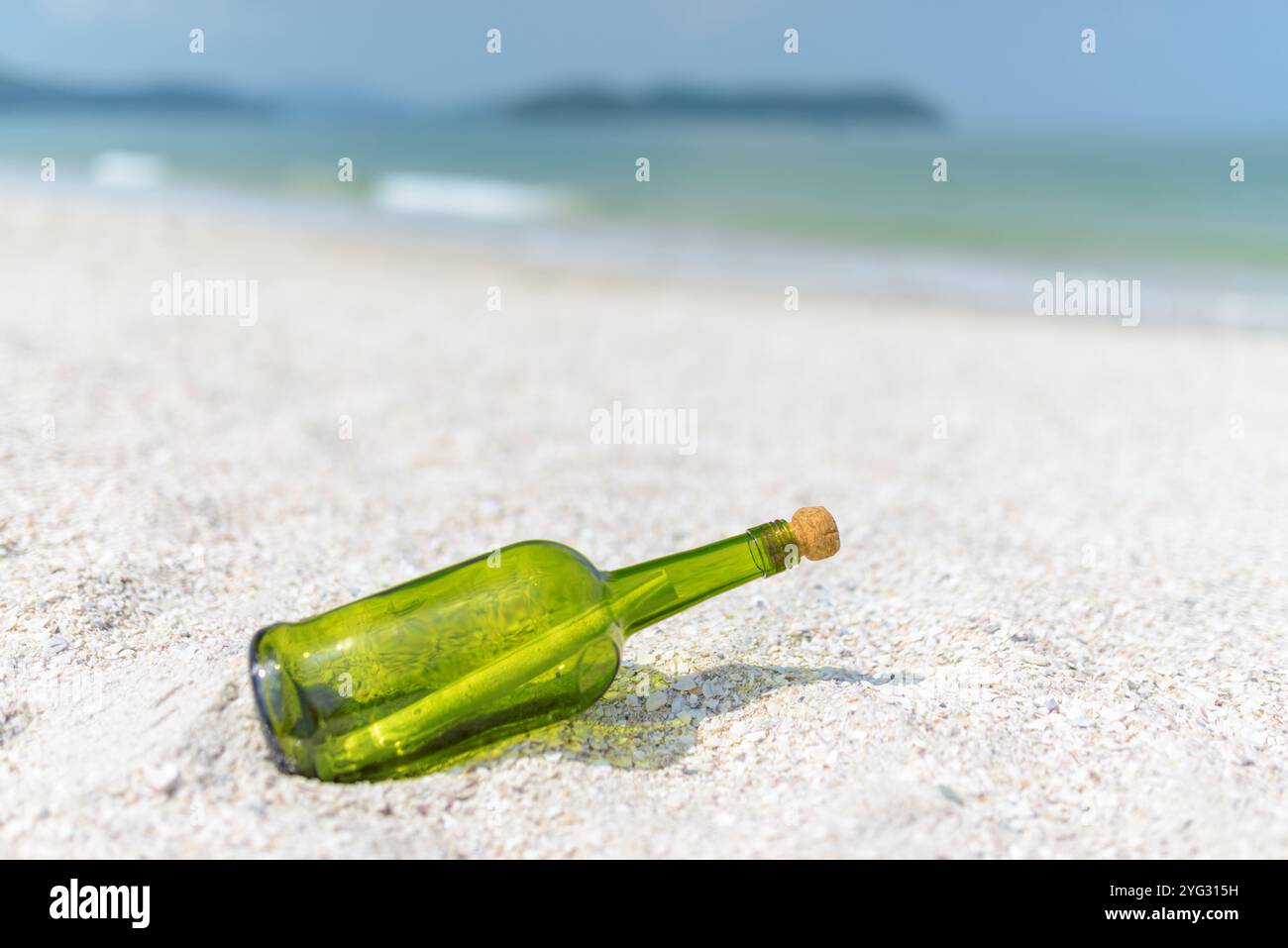 Message in a bottle (MIB) on a sand beach Stock Photo