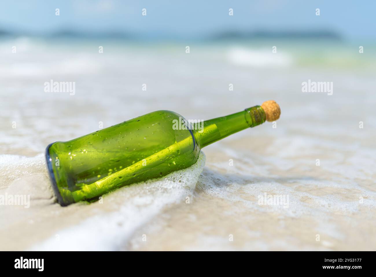 Message in a bottle (MIB) on a sand beach Stock Photo