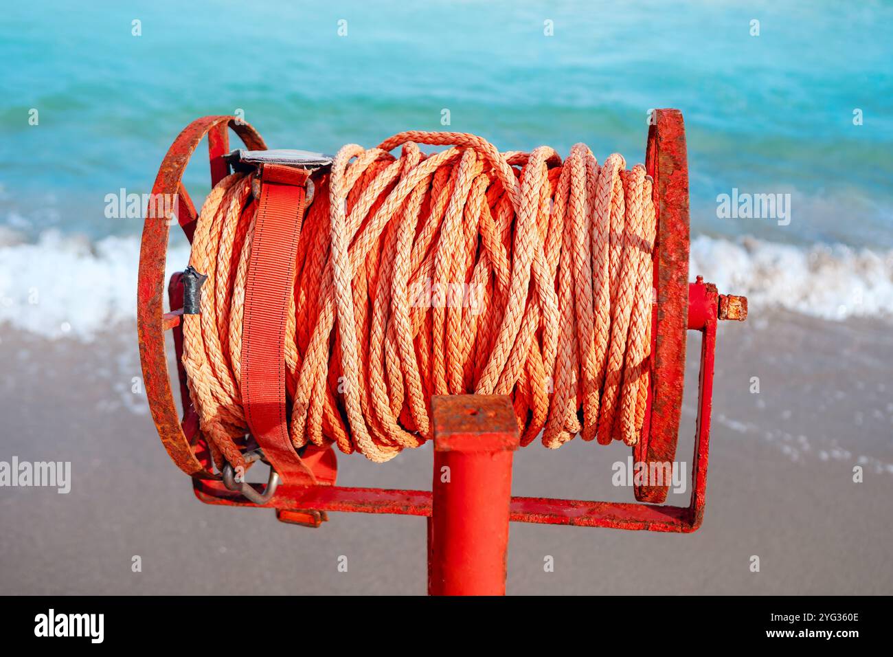 Marine rescue rope on beach, sea waves in background Stock Photo - Alamy