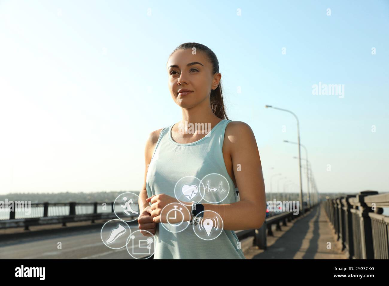 Woman with modern smart watch during training outdoors. Icons near device Stock Photo