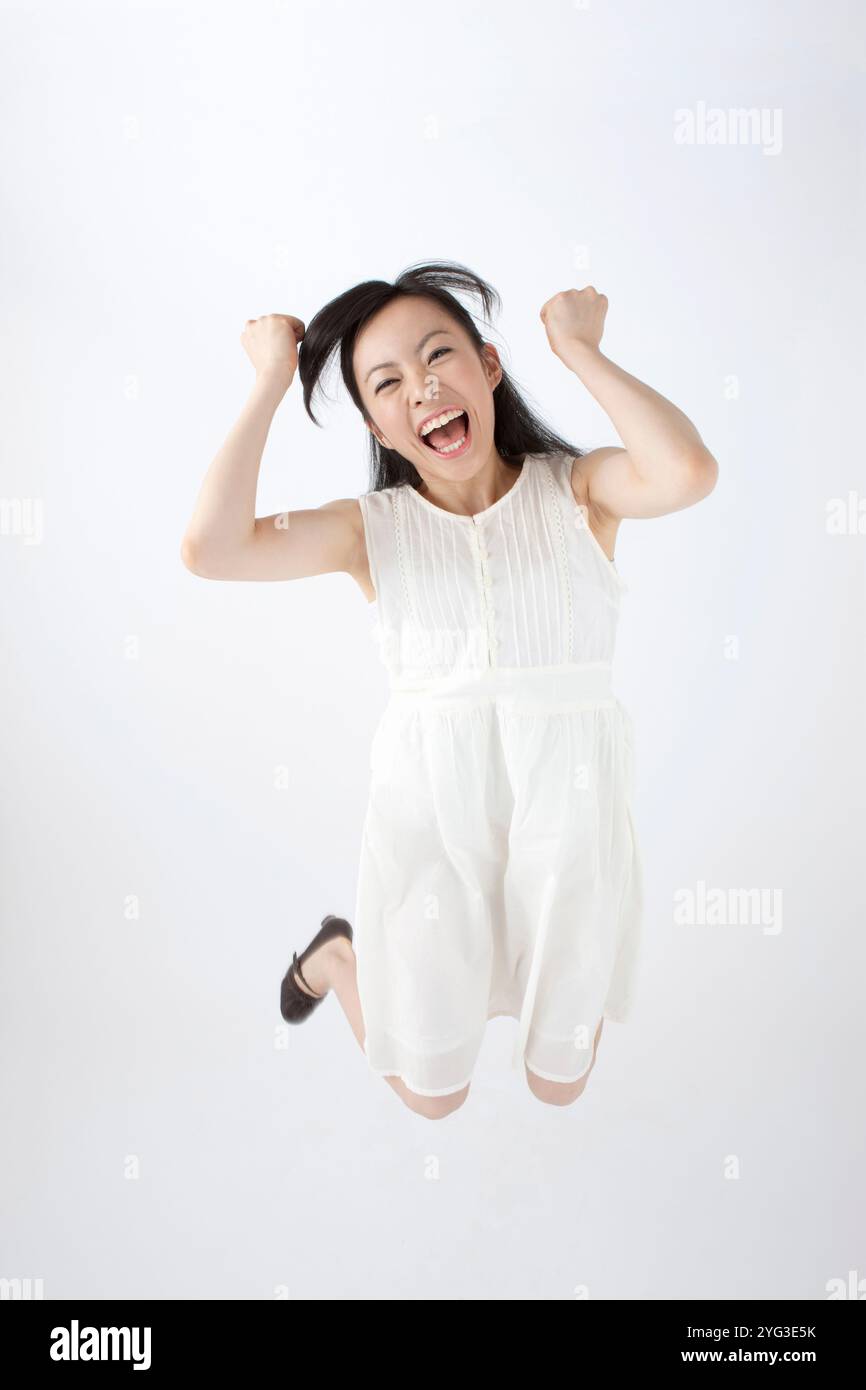 Jumping pose happy hi-res stock photography and images - Alamy