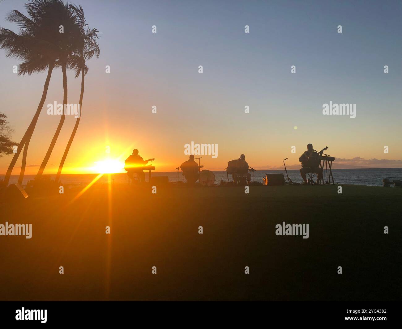 Sunset Hawaii with Musicians at lūʻau on Maui - Smartphone Captured Stock Image