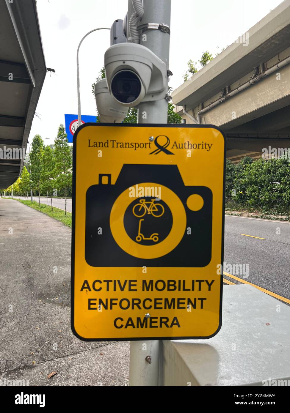 Active mobility enforcement camera located at the side of a pedestrian path to catch errant cyclists and personal mobility device users. Singapore - Smartphone Captured Stock Image
