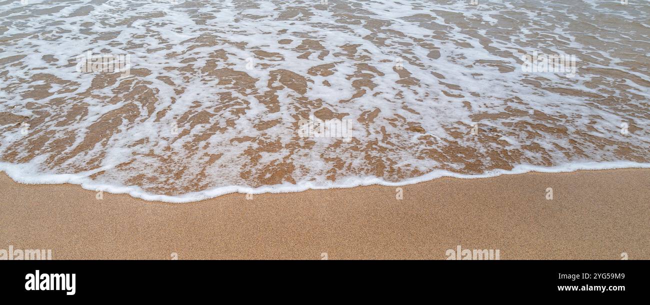 A panoramic image of the sea slowly creeping in on a beach in Cornwall ...