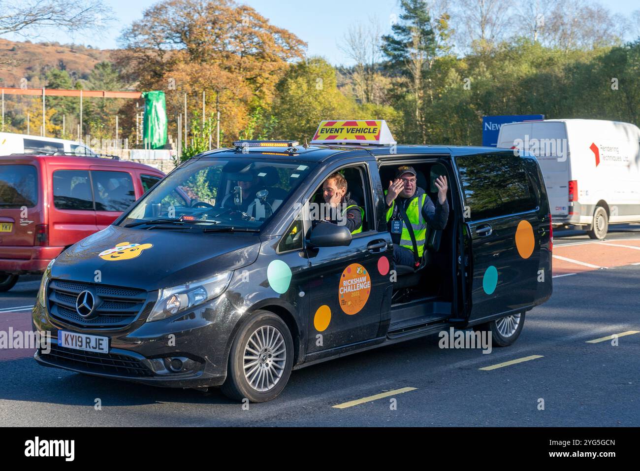 BBC Children in Need appeal teams event vehicle  with TV personality Matt Baker following on bicycles through the English Lake District raising money Stock Photo