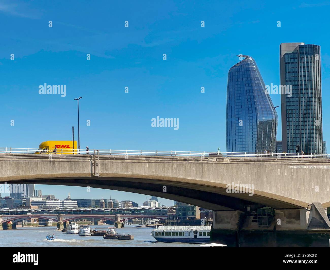london, England, UK - 22 August 2023: DHL delivery van crossing on of the road bridges over the River Thames in central London - Smartphone Captured Stock Image