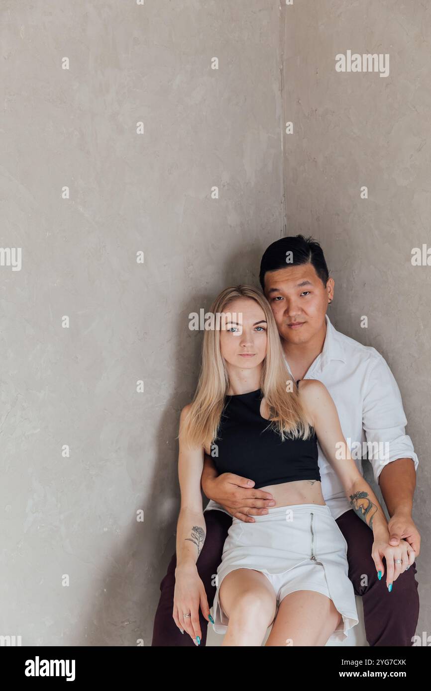 Man And Woman Sitting Together Side By Side Hugging Stock Photo - Alamy