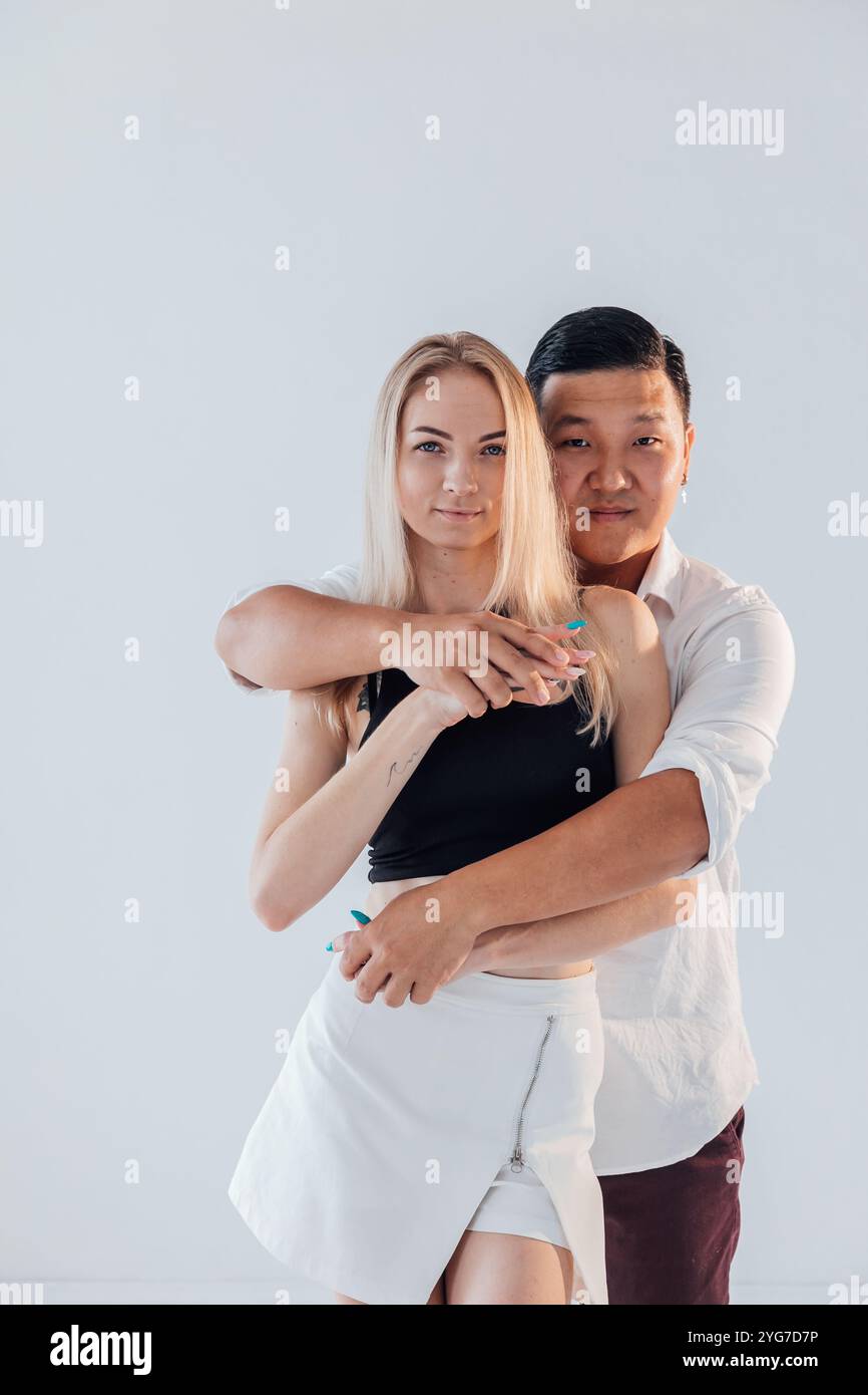 Man and woman standing side by side hugging Stock Photo - Alamy