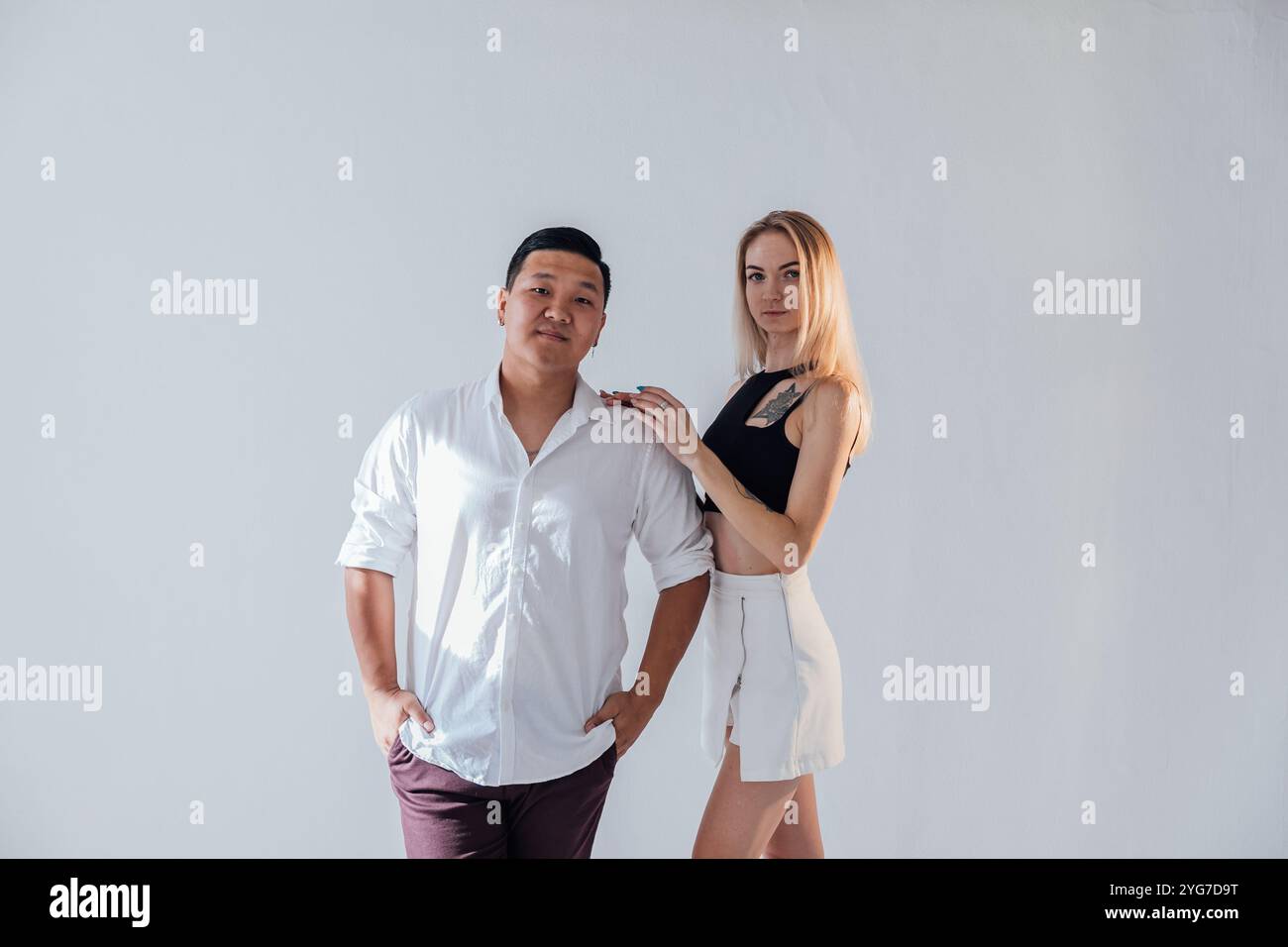 Man and woman standing side by side hugging Stock Photo - Alamy