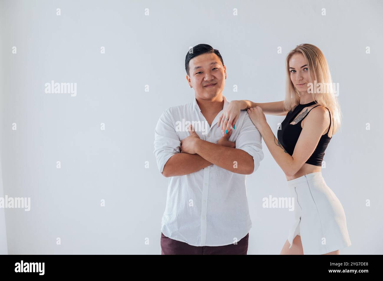 Man and woman standing side by side hugging Stock Photo - Alamy
