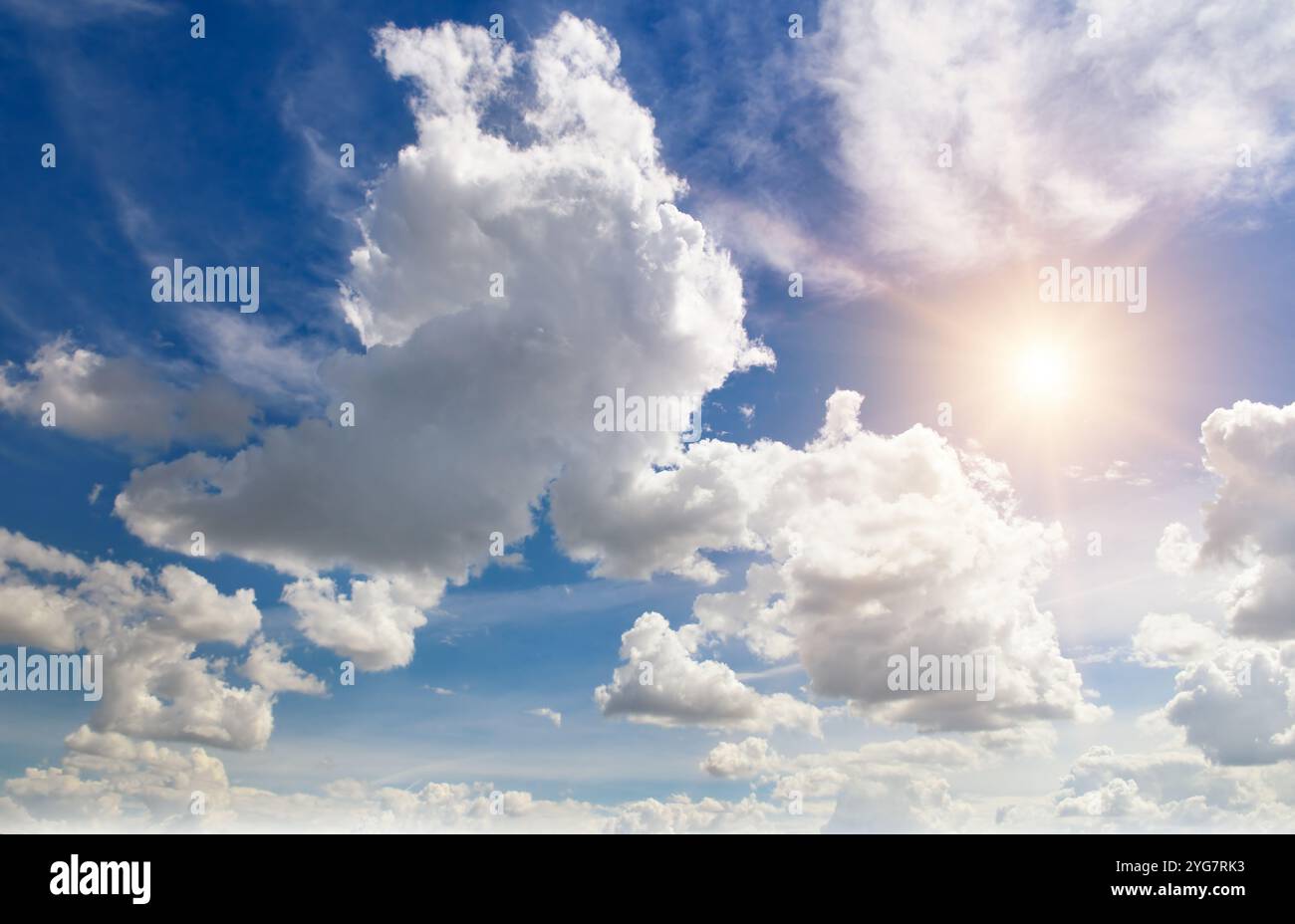 Blue sky with white clouds and bright sun Stock Photo - Alamy