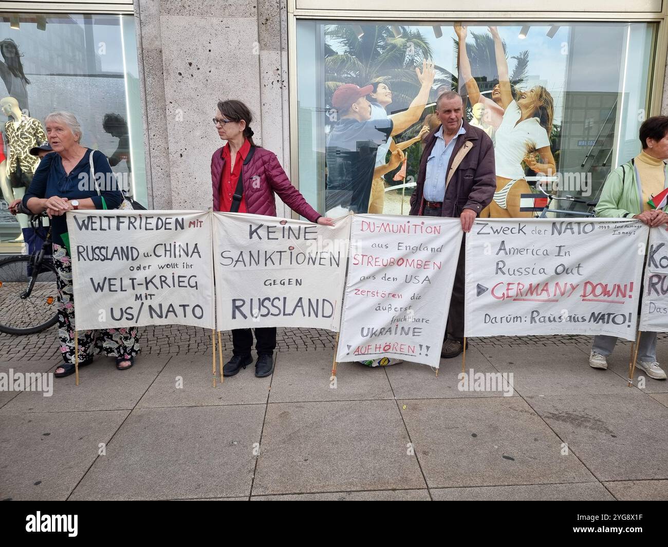 Protesters with banners against the NATO, against sanctions against Russia, for world peace with Russia & China; in Berlin, Germany - Smartphone Captured Stock Image