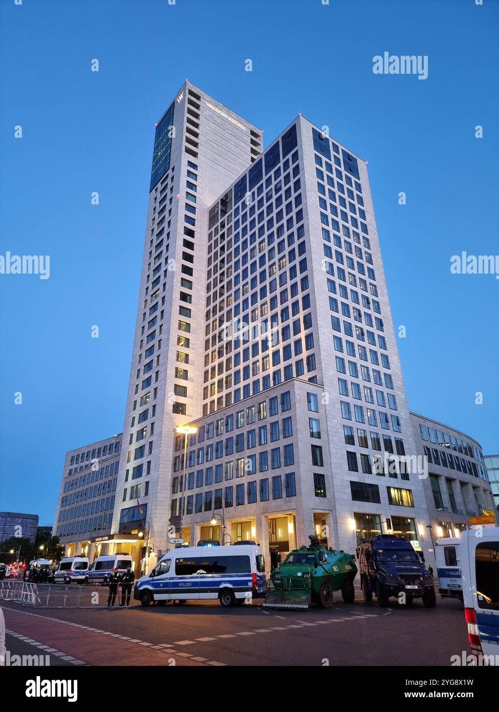 Armoured vehicles & police cars in front of Waldorf Astoria Berlin hotel Germany, where president Zelensky stayed for Ukraine Recovery Conference 2024 - Smartphone Captured Stock Image