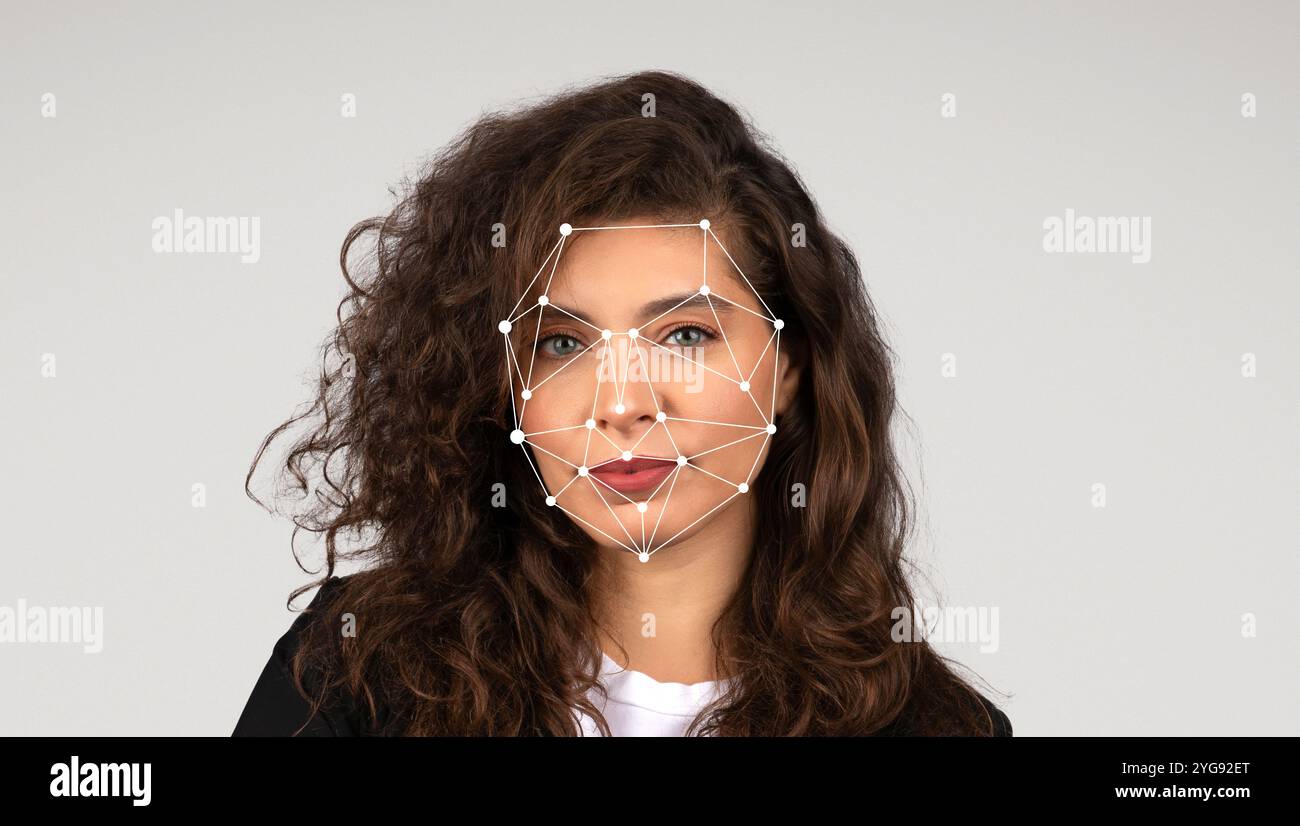 A woman with curly hair poses for a digital facial recognition analysis ...
