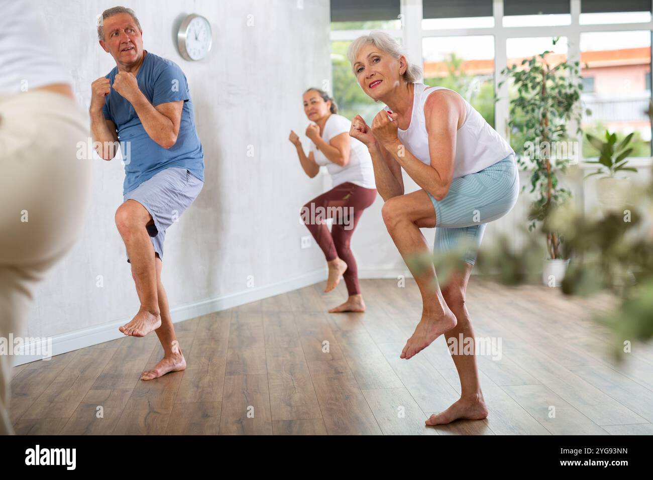 mature-woman-with-visitor-actively-moves-and-learns-to-dance-hip-hop
