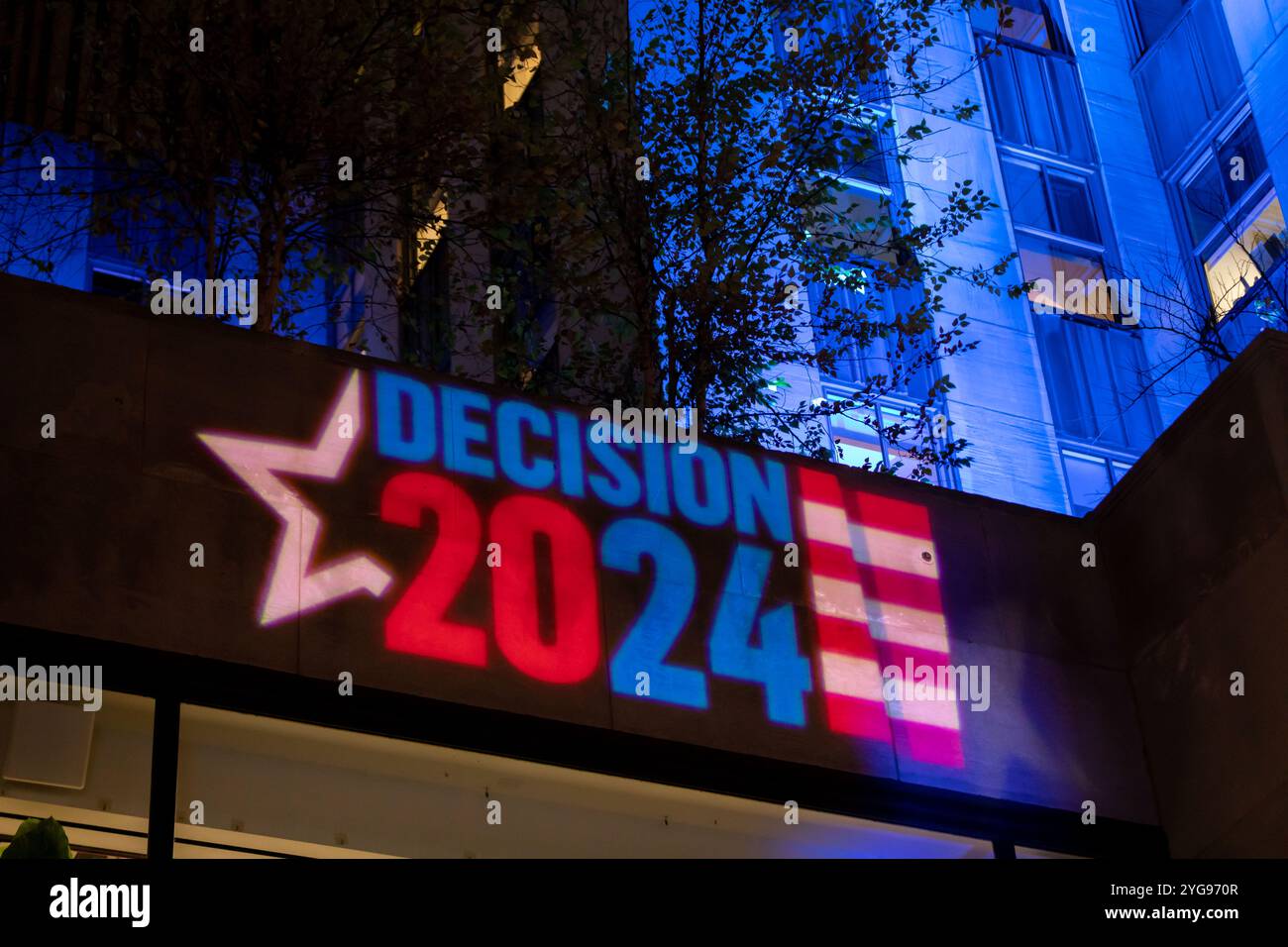 New York, United States. 05th Nov, 2024. NEW YORK, NEW YORK - NOVEMBER 5: Onlookers watch as the 2024 U.S. Presidential election results are broadcast outside Rockefeller Center on November 5, 2024 in New York City. Donald Trump was elected the 47th president of the United States, pulling off a stunning political comeback in one of the most polarized contests for the White House in US history.? (Photo by Michael Nigro/Sipa USA) Credit: Sipa USA/Alamy Live News Stock Photo