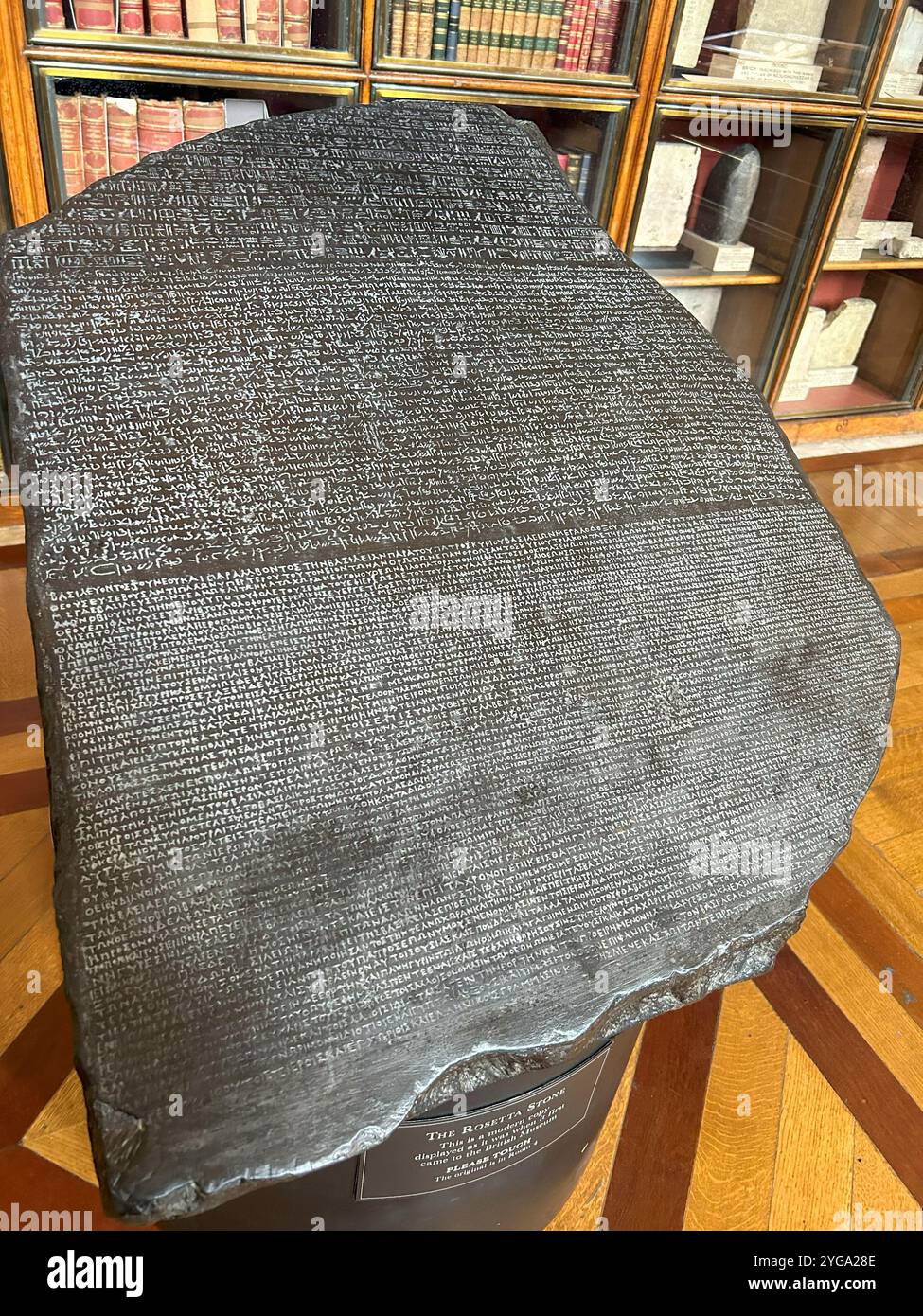 The Rosetta Stone is a fascinating artifact due to its crucial role in deciphering ancient Egyptian hieroglyphics - Smartphone Captured Stock Image The Rosetta Stone is a fascinating artifact due to its crucial role in deciphering ancient Egyptian hieroglyphics - Smartphone Captured Stock Image