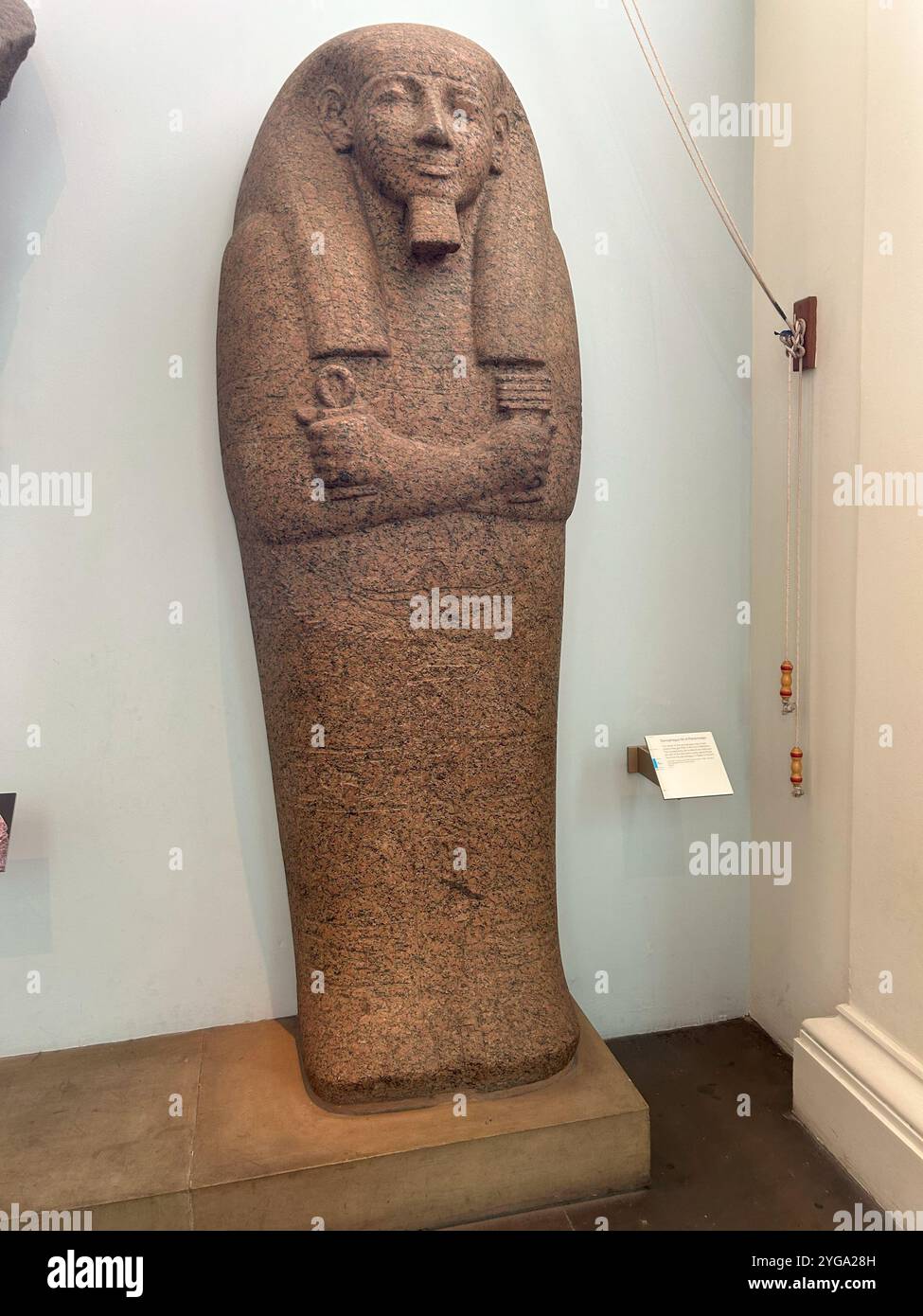 The image shows an ancient Egyptian sarcophagus, which is a stone coffin typically adorned with carvings and inscriptions. - Smartphone Captured Stock Image The image shows an ancient Egyptian sarcophagus, which is a stone coffin typically adorned with carvings and inscriptions. - Smartphone Captured Stock Image