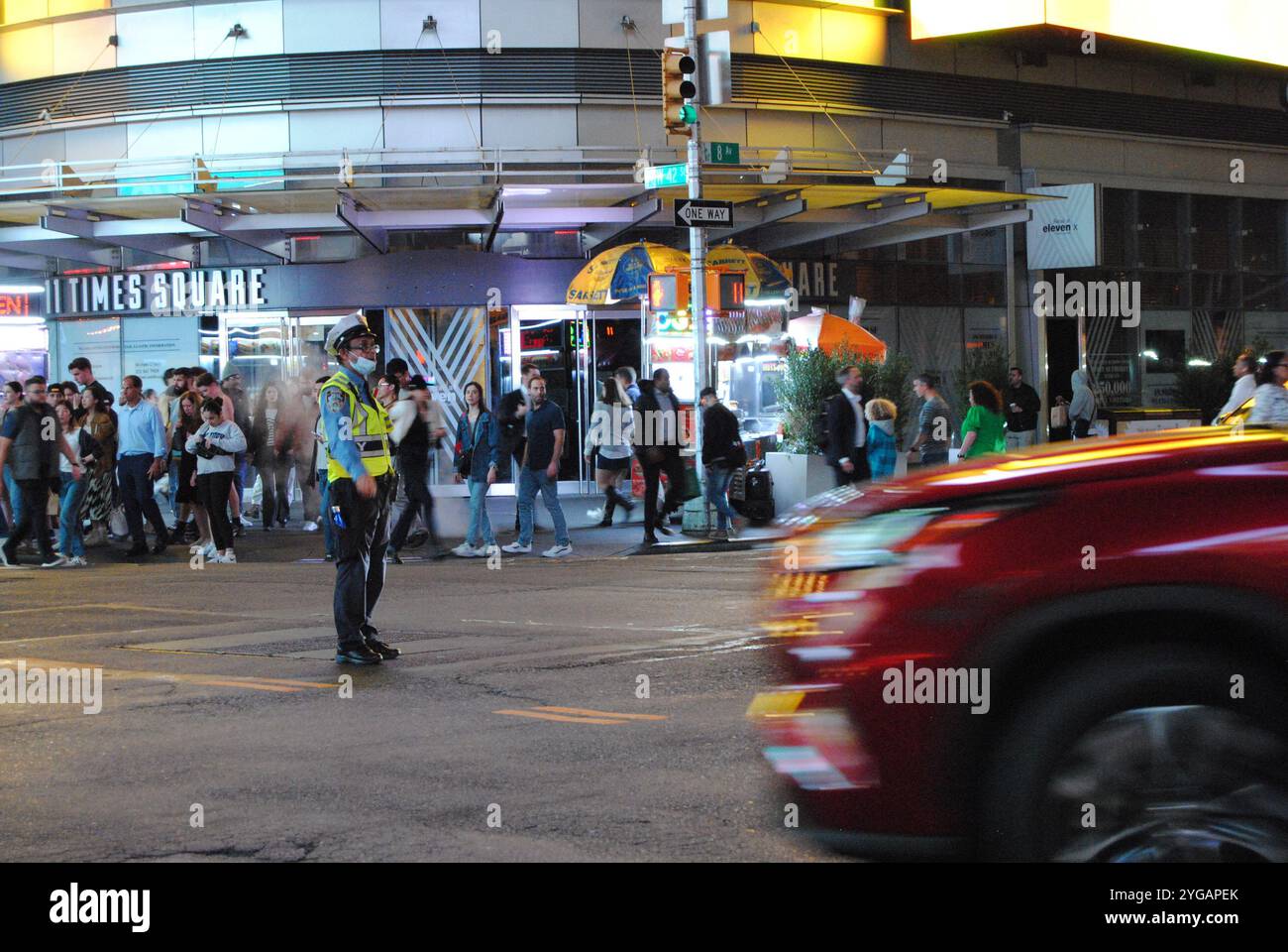 New York City, New York, USA - November 06 2024: Officer directing traffic at the intersection of 42nd Street and 8th Avenue in Manhattan. Stock Photo