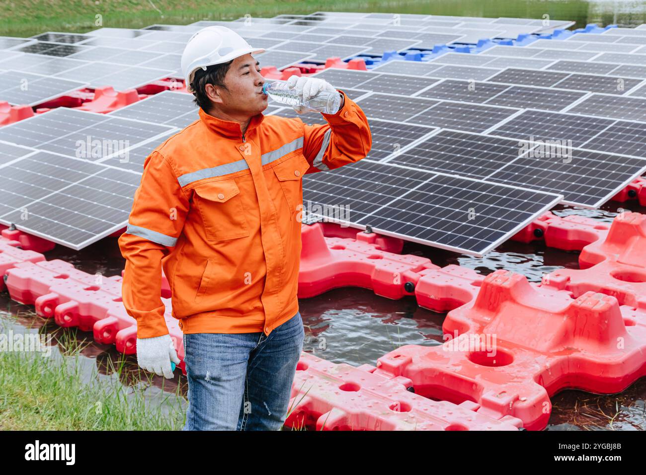 View of Engineer Foreman Drinking Water while Installation Floating Solar ...